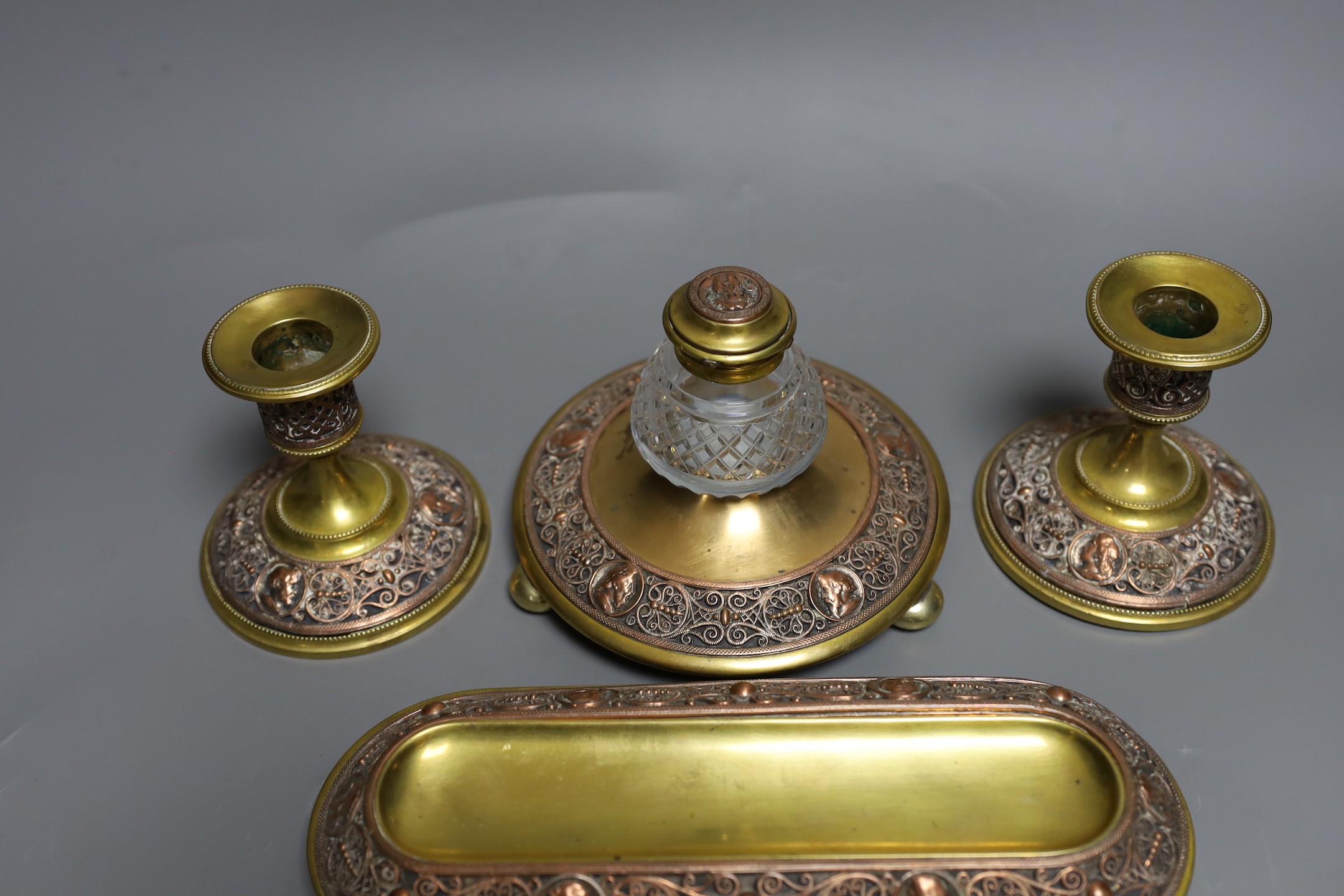 A brass and filigree worked copper desk set (4), inkwell 10.5 cms high